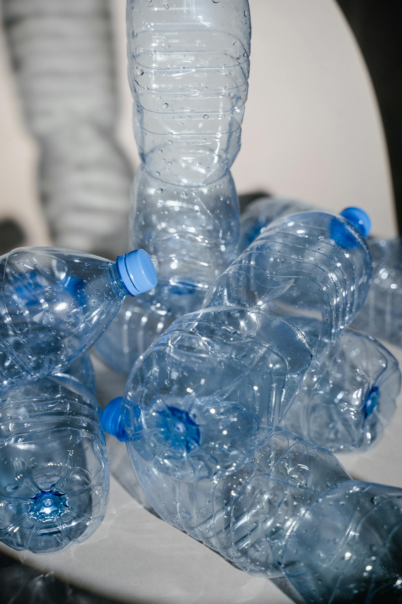 A vertical shot of empty plastic bottles stacked for recycling, emphasizing environmental themes.